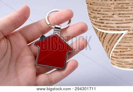 Hand Holding A House Icon In Hand On A Background