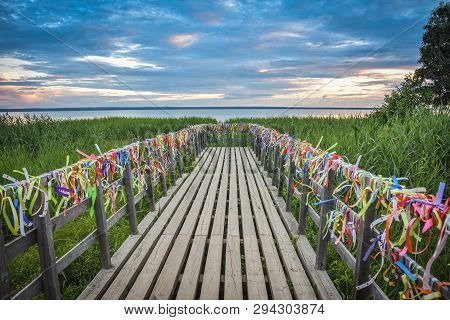 Bridge On The Lake With Colorful Ribbons, Bridge At Sunset, Colorful Ribbons On The Railing Of The B