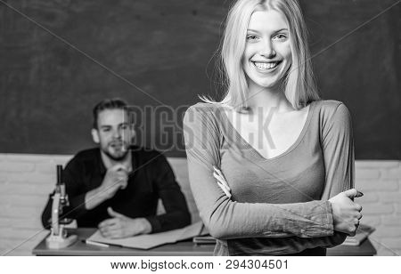 Happy Woman Standing Hands Crossed In Classroom With Teacher. Female Student With Schoolmaster At Ex