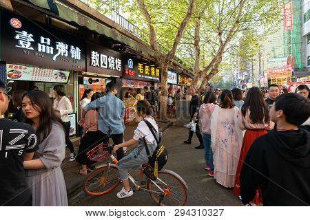 6 April 2019, Wuhan Hubei China : Girl On A Mobike Bike On The Line For Street Food Shops In Wuhan C