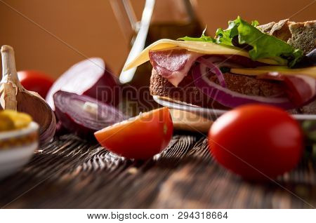 Sandwich With Bacon, Cheese, Garlic, Jalapeno Pepper And Herbs On A Plate, On A Wooden Background