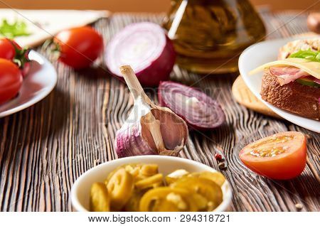 Sandwich With Bacon, Cheese, Garlic, Jalapeno Pepper And Herbs On A Plate, On A Wooden Background
