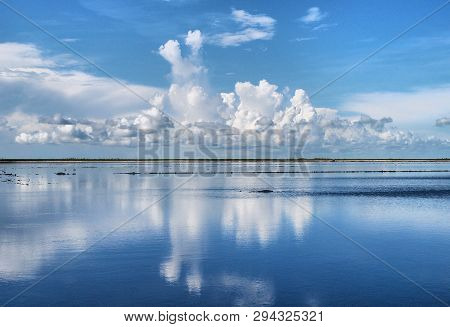 Cloud Reflections Over Flooded Sod Fields In South Florida