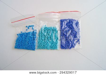 Set Of Three Plastic Bags With Blue Glass Beads With Gradient Color On White Background, Beaded Embr