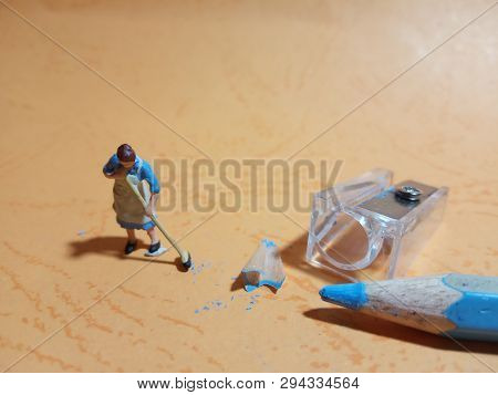Photo 1 Woman Cleaning Trash From Pencil Sharpener With Negative Space
