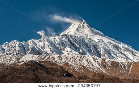 View Of Snow Covered Peak Of Mount Manaslu (8 156 Meters) With Clouds In Himalayas, Sunny Day At Man