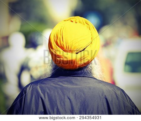 Sikh Man With Yellow Turban And Long White Beard With Vintage Toned Effect