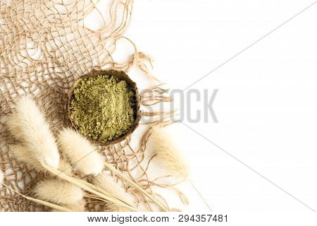 Henna Powder For Dyeing Hair And Eyebrows And Drawing Mehendi On Hands, Isolate With Green Palm Leaf