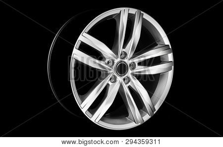 Aluminium Modern Car Wheel Rim In Dramatic Light At Night. Vehicle Rim Isolated On Black Background.