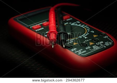 Digital Multimeter For Different Electrician Measurement Isolated On Black Background.