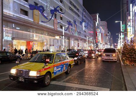 Tokyo, Japan - December 4, 2016: Taxi Drives In Ginza District Of Tokyo, Japan. Ginza Is A Legendary