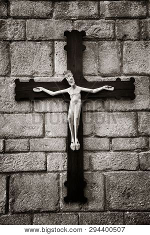 Jesus statue on wall. Romanesque monastery in village in Pueblo Espanol Barcelona, Spain