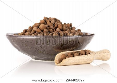 Lot Of Whole Brown Clay Pebbles (leca) On Grey Ceramic Plate With Wooden Scoop Isolated On White Bac