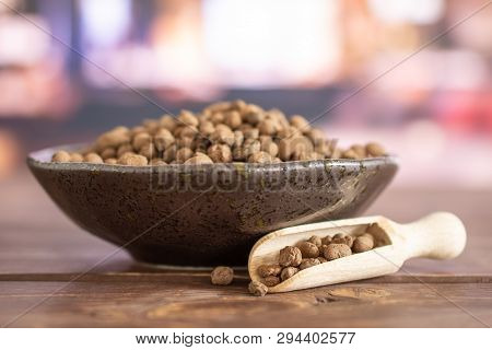 Lot Of Whole Brown Clay Pebbles (leca) On Grey Ceramic Plate With Wooden Scoop In A Restaurant