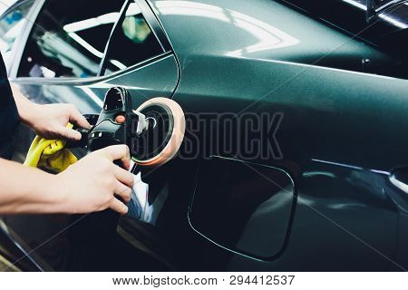 Car Polish Wax. Worker Hands Holding A Polisher And Polish Car.