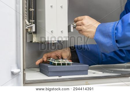 Scientist Wearing Blue Unifrom And Use X Ray Or Rontgen In Laboratory