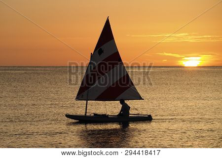 Captiva Island, Florida 08-05-2015 Active Senior Sails A Sunfish In Late Afternoon Light Off The Bea
