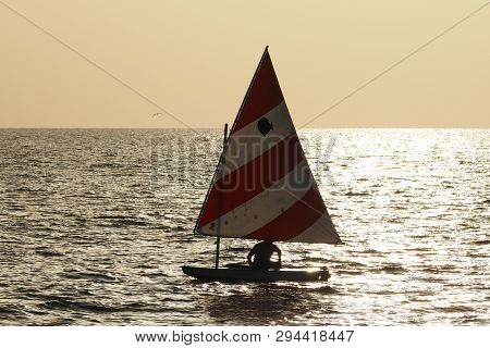 Captiva Island, Florida 08-05-2015 Active Senior Sails A Sunfish In Late Afternoon Light Off The Bea