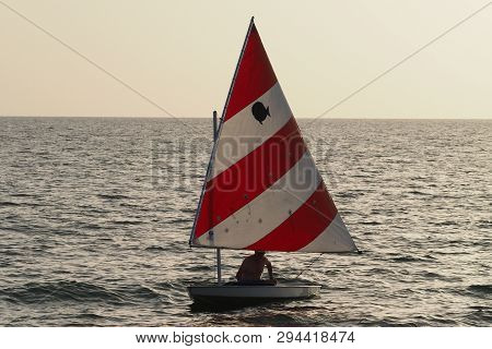 Captiva Island, Florida 08-05-2015 Active Senior Sails A Sunfish In Late Afternoon Light Off The Bea
