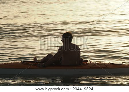 Captiva Island, Florida 08-05-2015 Young Man Kayaks Off The Beach In Captiva Island In Partial Silho