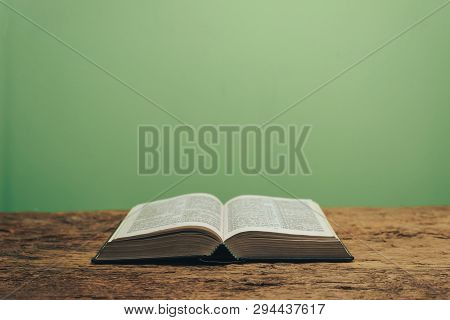 Open Bible On A Green Background. Religious Concept.
