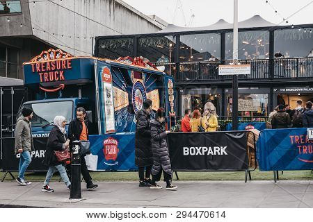 London, Uk - April 6, 2019: People Walking Past Amazon Truck Parked At Boxpark Shoreditch, Shipping 