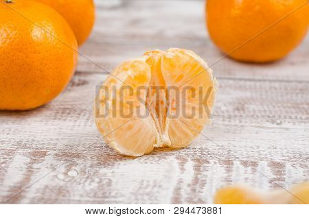 Peele Dripe Tangerines On Wooden Light Background