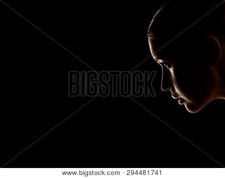 Sad Woman Profile Silhouette On Black Background With Copy Space, Looking Down