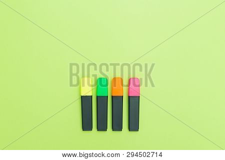 Colorful Text Markers On Greenbackground. Copy Space. Flatlay.