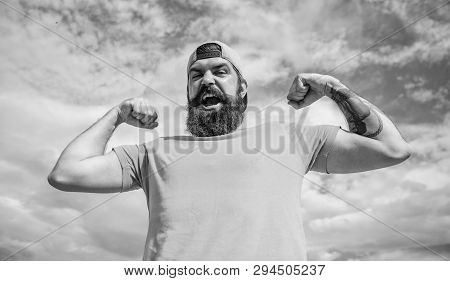 Powerful And Free. Man Bearded Muscular Brutal Hipster Outdoors Sky Background. Masculinity And Brut