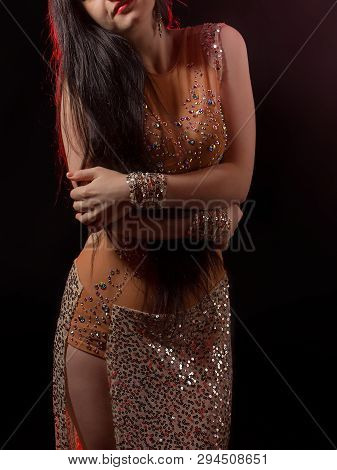 Girl With A Smart Figure Poses In A Beautiful Beige Dress For Belly Dance, Fusion, Tribal. A Woman I