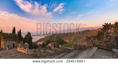Panoramic View Of Smoking Snow-capped Mount Etna Volcano At Sunrise, As Seen From Taormina, Sicily