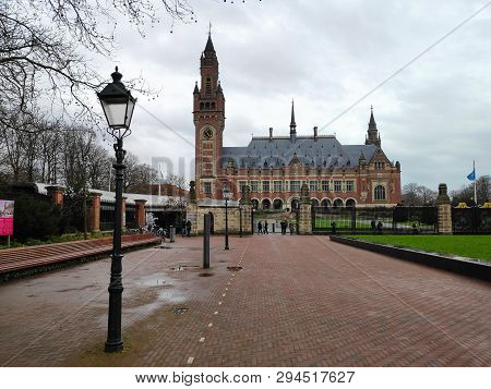 The Peace Palace Of The Hague With Square And Lantern In Front At Cloudy Day