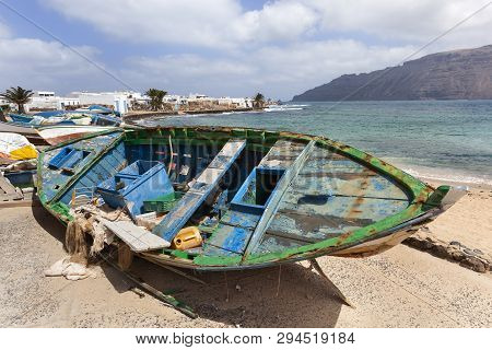 Dirty Old Weathered Broken Boats At The Coast Of Caleta De Sebo On The Island La Graciosa Of Lanzaro