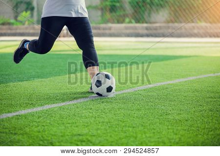 Women Soccer Player Put Black Sport Shoes And Run For Shoot Ball To Goal On Artificial Turf