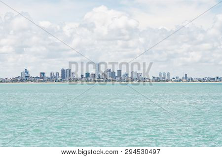 Bessa Beach Seen From The Middle Of The Sea. Buildings By The Sea At Praia Do Bessa And The City Of 