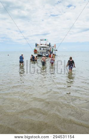 Joao Pessoa - Pb, Brazil - February 21, 2019: Tourists Entering The Sea To Reach The Catamaran At Be