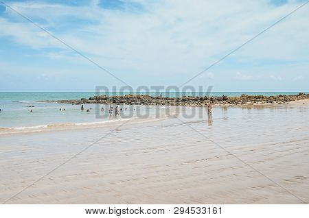 Conde - Pb, Brazil - February 22, 2019: Local People And Tourists At The Water Of Praia De Coqueirin