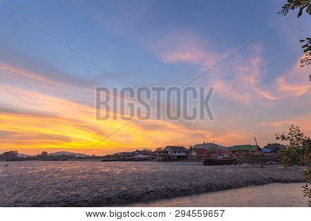 Stunning Sunset At Fishing Village In Phuket.during Low Tide Will Has A Small Canal Beside Fishing V
