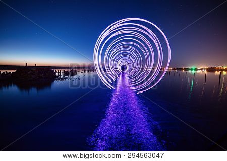 Amazing Laser Fireshow Performance In The Night Blue Sky With Reflections In The Sea Water