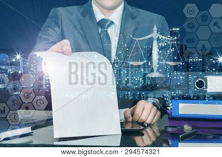A Closeup Of Businessman At Table Showing Contract To Sign With Scales And Business Structure Scheme