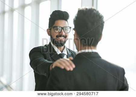 Smile Indian Businessmen Pat On The Shoulder In The Office