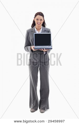 Businesswoman smiling while showing a laptop screen against white background
