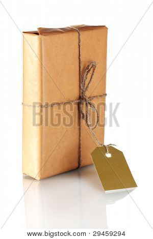 Parcel wrapped in brown paper tied with twine and with blank label isolated on white