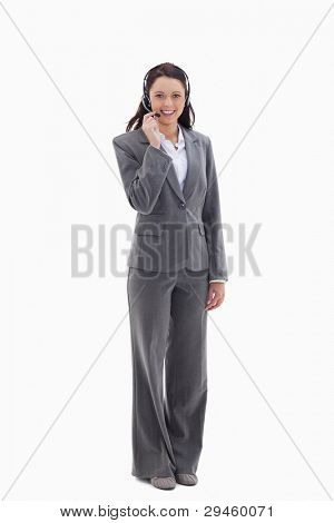 Businesswoman smiling and speaking with a headset against white background