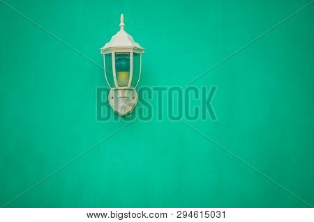 Emerald Vintage Lamp On Emerald Wall. Design Exterior In Emerald Green Virid Tones