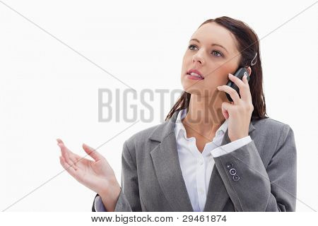Close up of a businesswoman on the phone explaining against white background