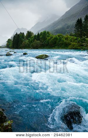 Milky blue glacial water of Briksdal River in Norway