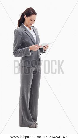 Profile of a businesswoman smiling while watching a touch pad against white bacground