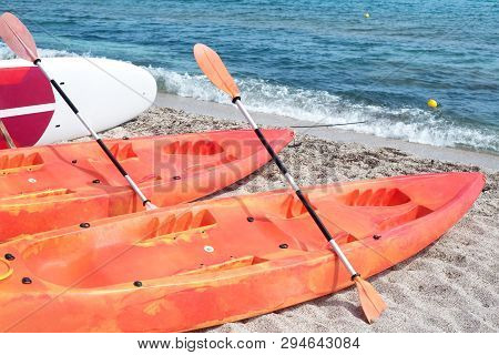 Kayaks On The Beach By The Sea